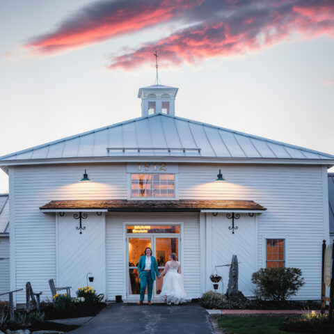2 brides in front of The 1812 barn
